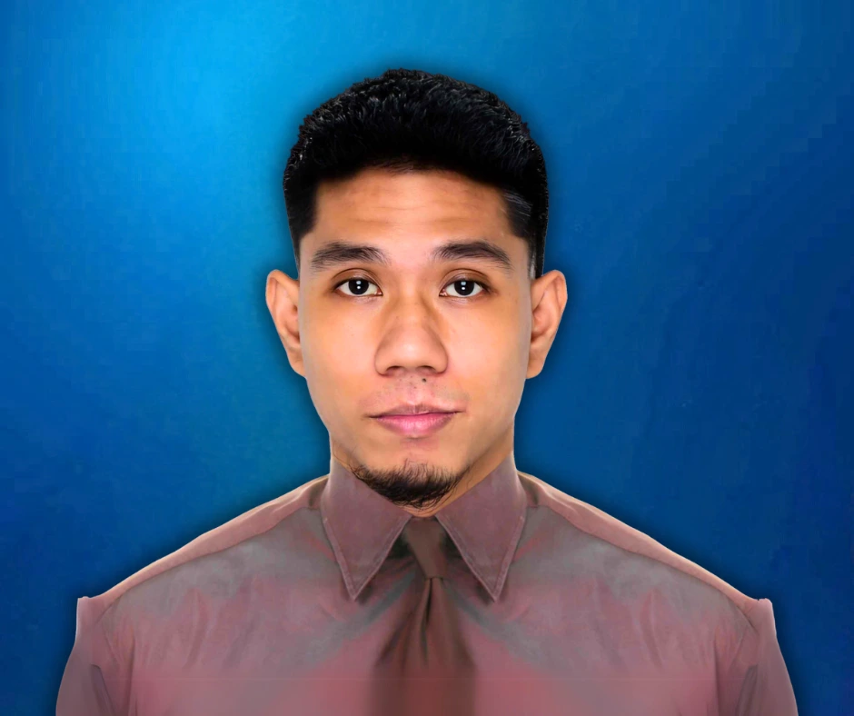 Sam, Apprenticeship Program Manager at ApprenticeSync, looking professional in a buttoned-up shirt with a confident expression against a blue background.